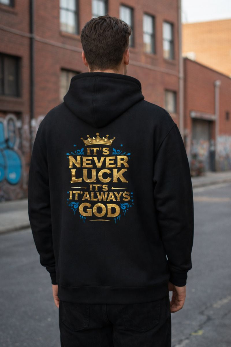 Black graphic hoodie featuring “It’s Never Luck, It’s Always God” faith quote design