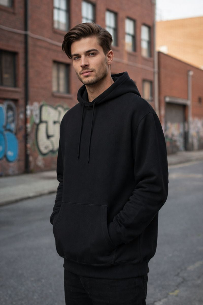 Front view of black cotton hoodie for men with clean minimal winter design